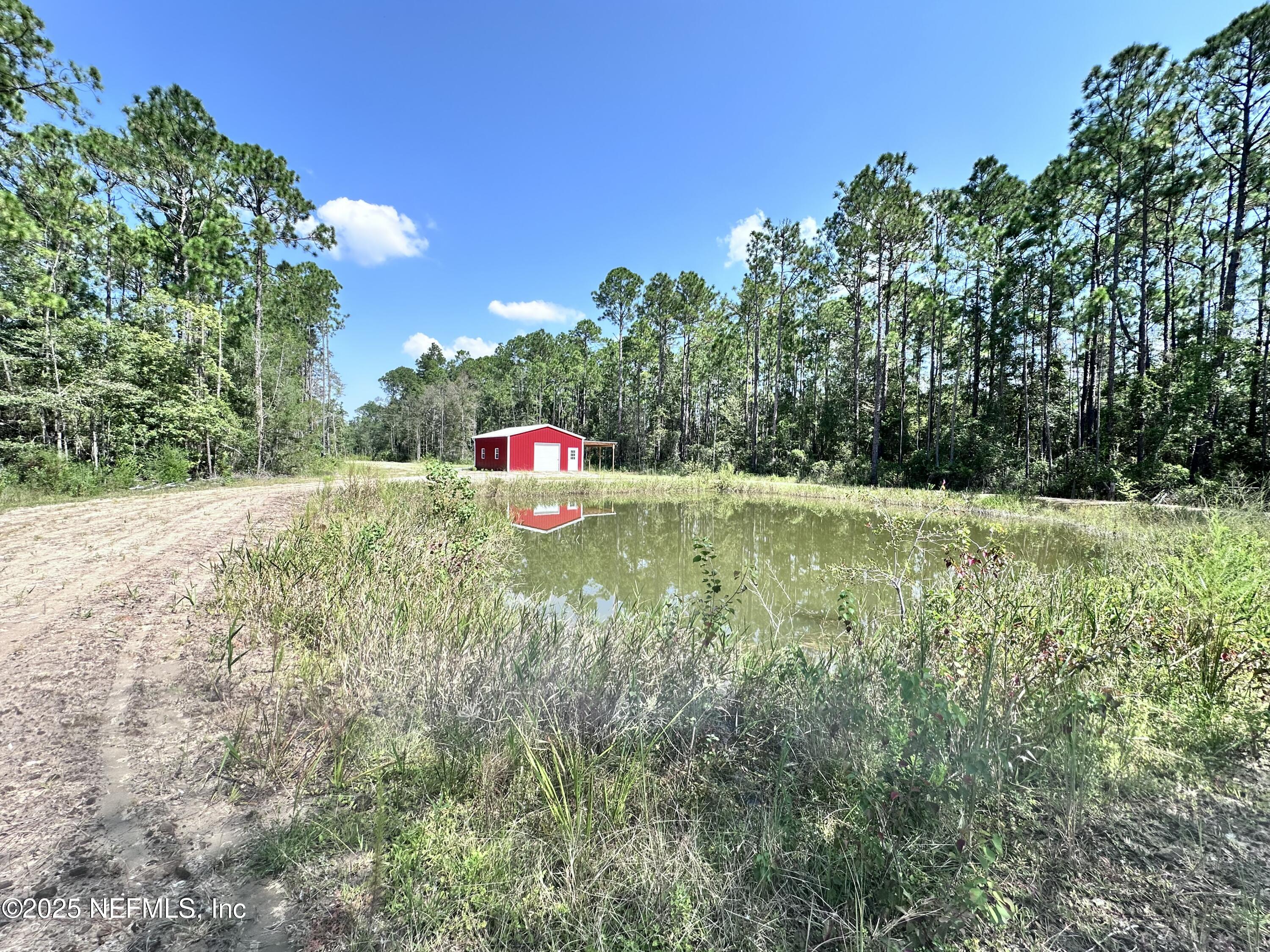 3269 Lannie Road Jacksonville, FL 32218 - Photo 2 of 7 a view of a green field with potted plants