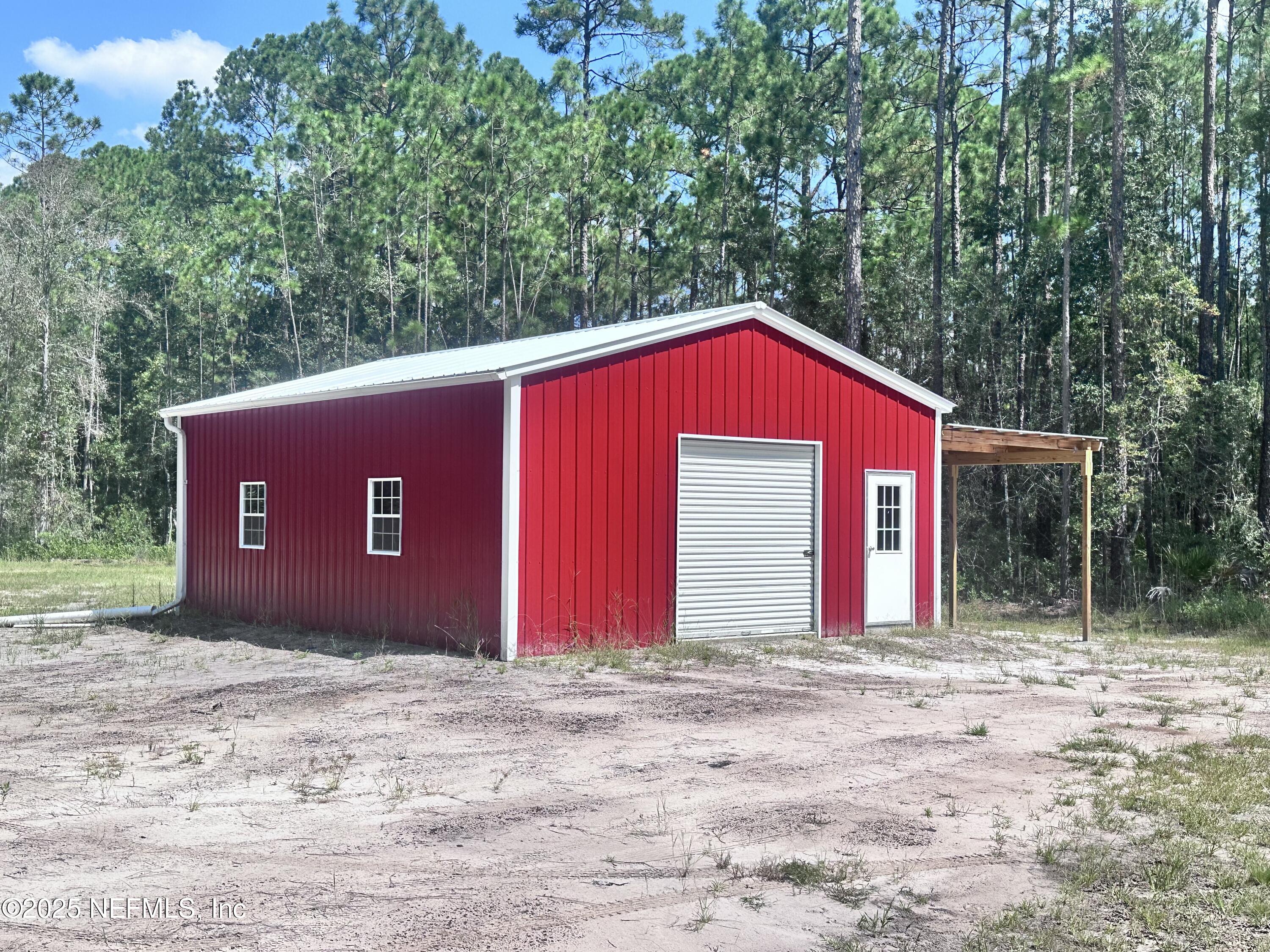 3269 Lannie Road Jacksonville, FL 32218 - Photo 3 of 7 a house with trees in the background