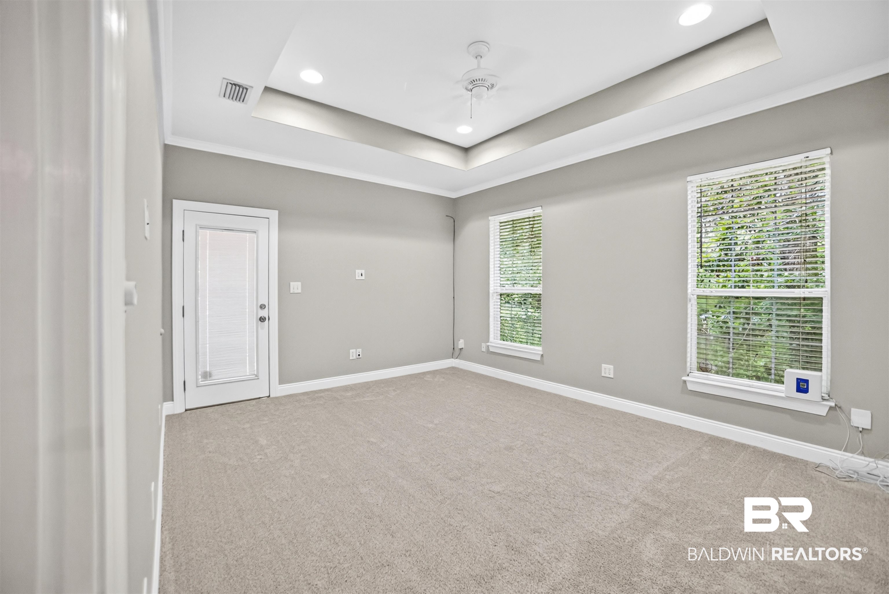 5913 Antoine Road Mobile, AL 36693 - Photo 12 of 33 Spacious room featuring tray ceiling with recessed lighting, ceiling fan, and light gray wall color