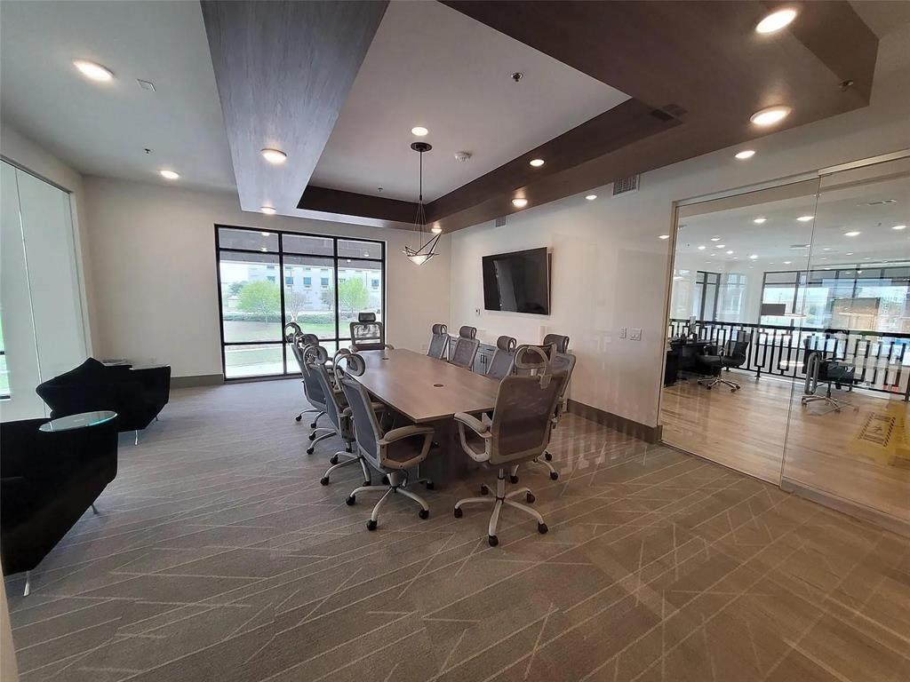 2700 Old Denton Road, Unit 2238 Carrollton, TX 75007 - Photo 6 of 21 Conference room featuring a large table with seating for ten, recessed lighting, and a prominent wall-mounted display