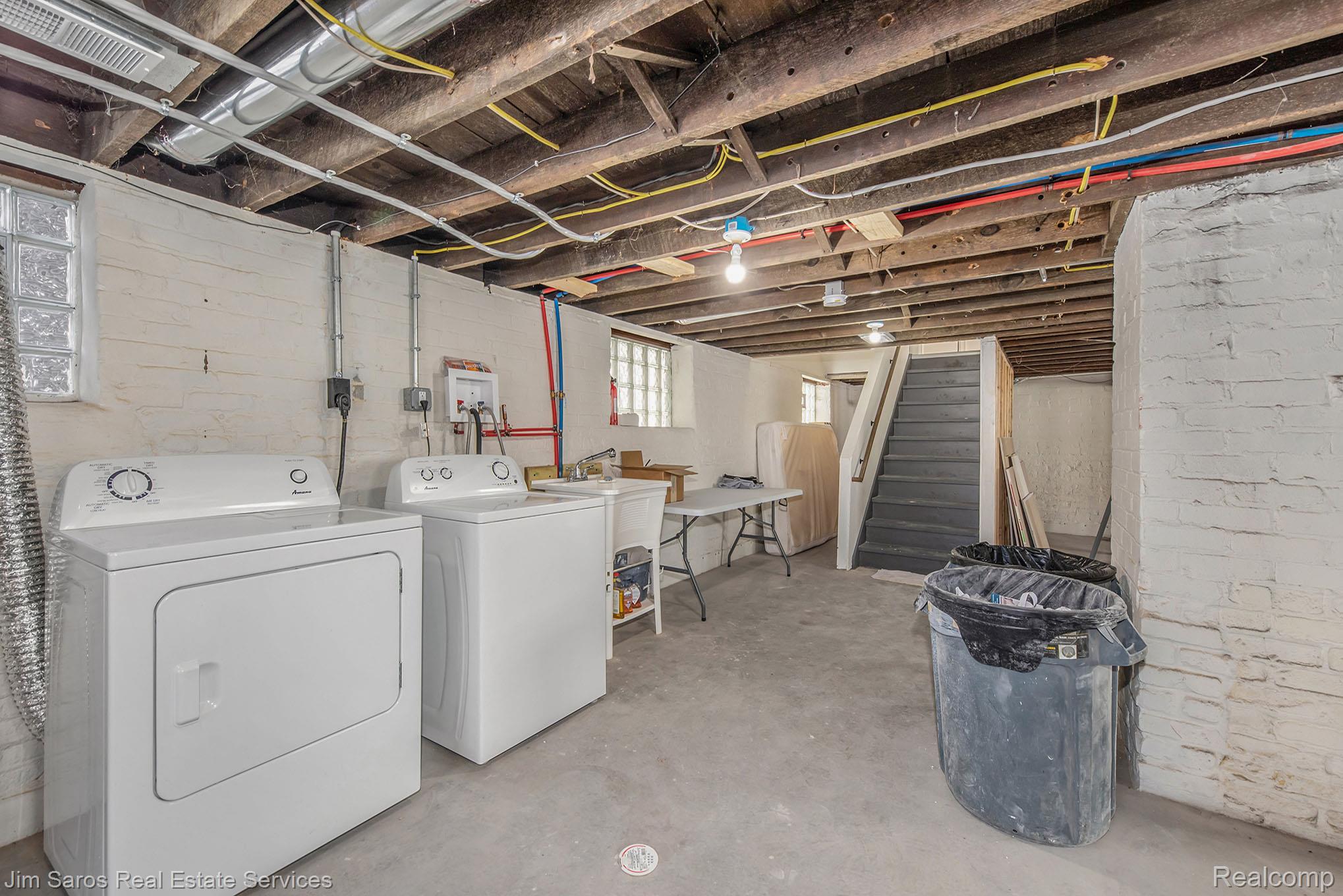 249 Custer Street Detroit, MI 48202 - Photo 22 of 22 Unfinished basement with exposed ceiling joists and concrete flooring