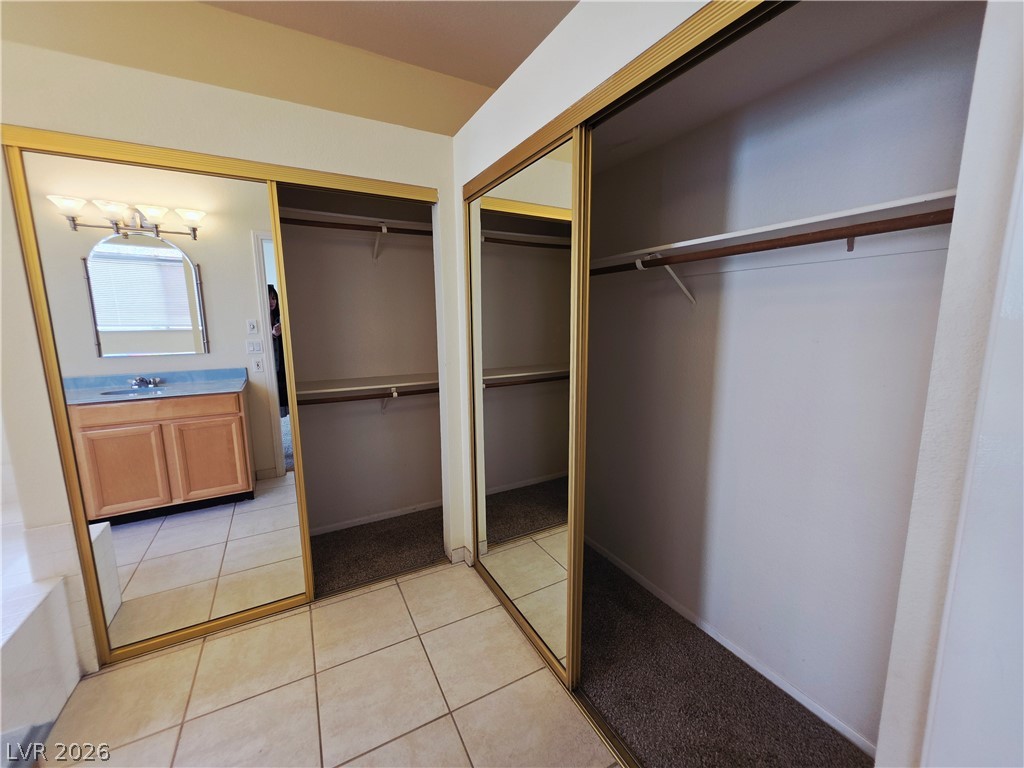 2920 Setting Sun Street Las Vegas, NV 89117 - Photo 27 of 43 This spacious area includes mirrored closet doors and durable tile flooring, creating a functional dressing space.