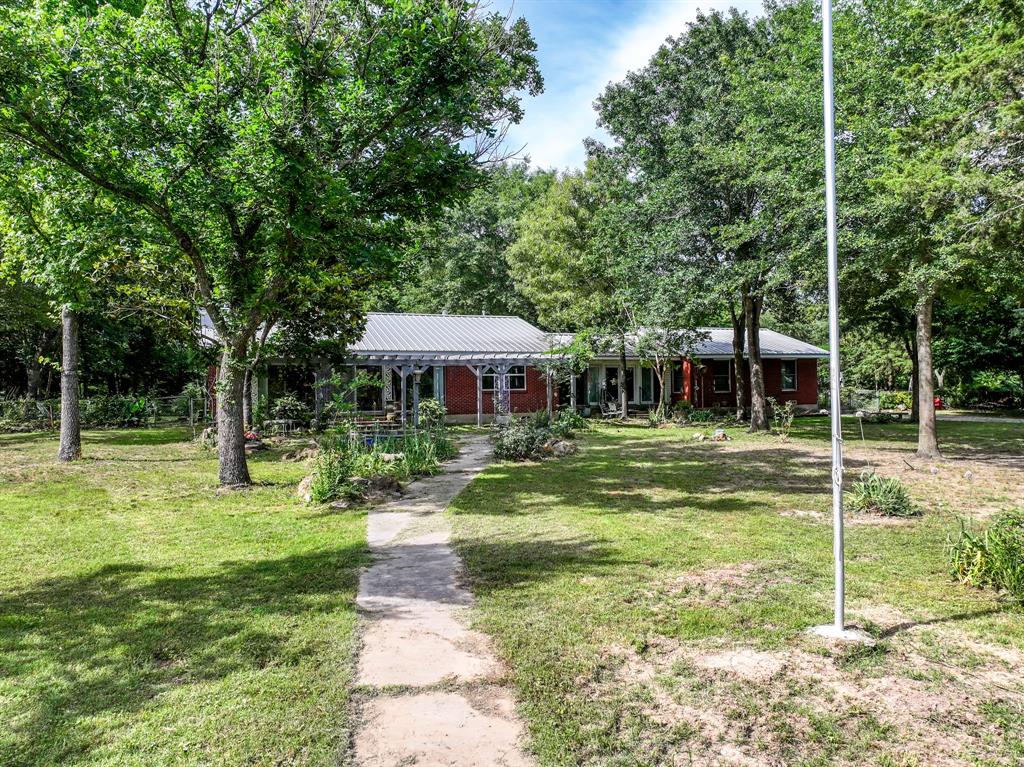 211 Rs County Road 1455 Point, TX 75472 - Photo 12 of 40 a front view of a house with garden