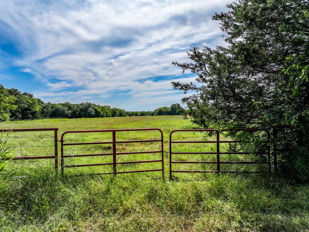 211 Rs County Road 1455 Point, TX 75472 - Photo 29 of 40 a view of a garden with a bench in the background