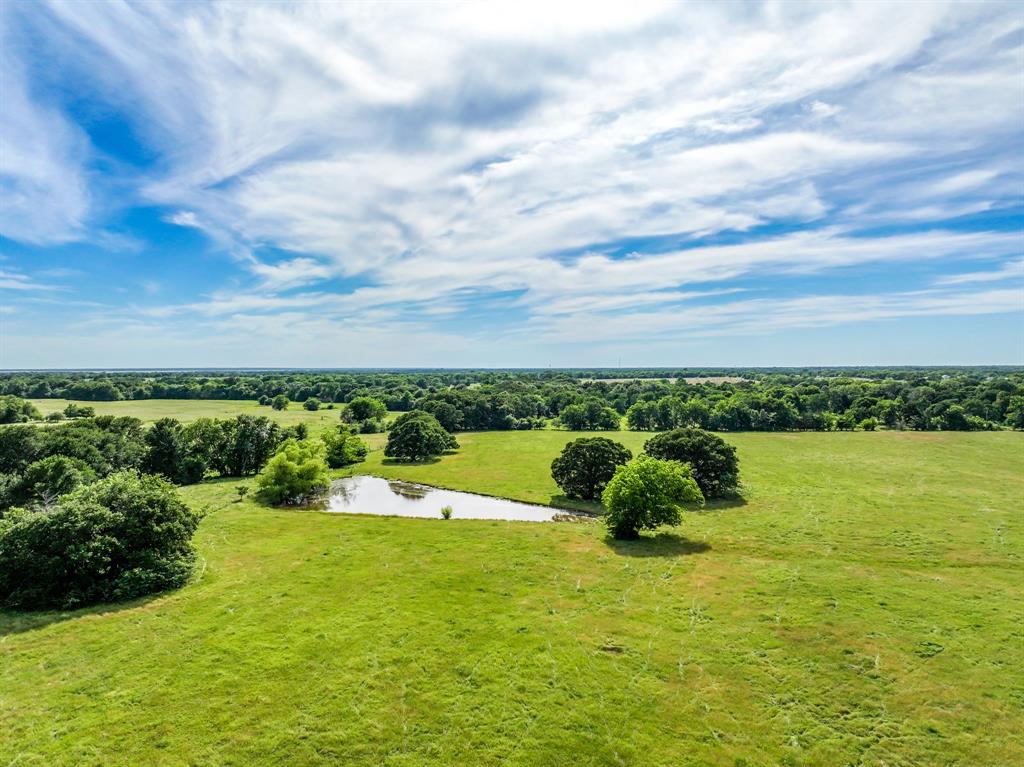 211 Rs County Road 1455 Point, TX 75472 - Photo 30 of 40 a large body of water with a building in the background