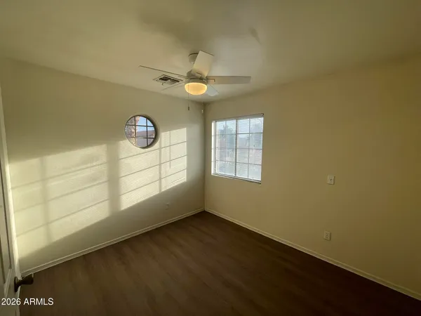 an empty room with windows and entrance