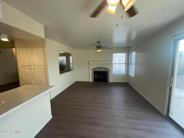 a view of empty room with a fireplace and wooden floor