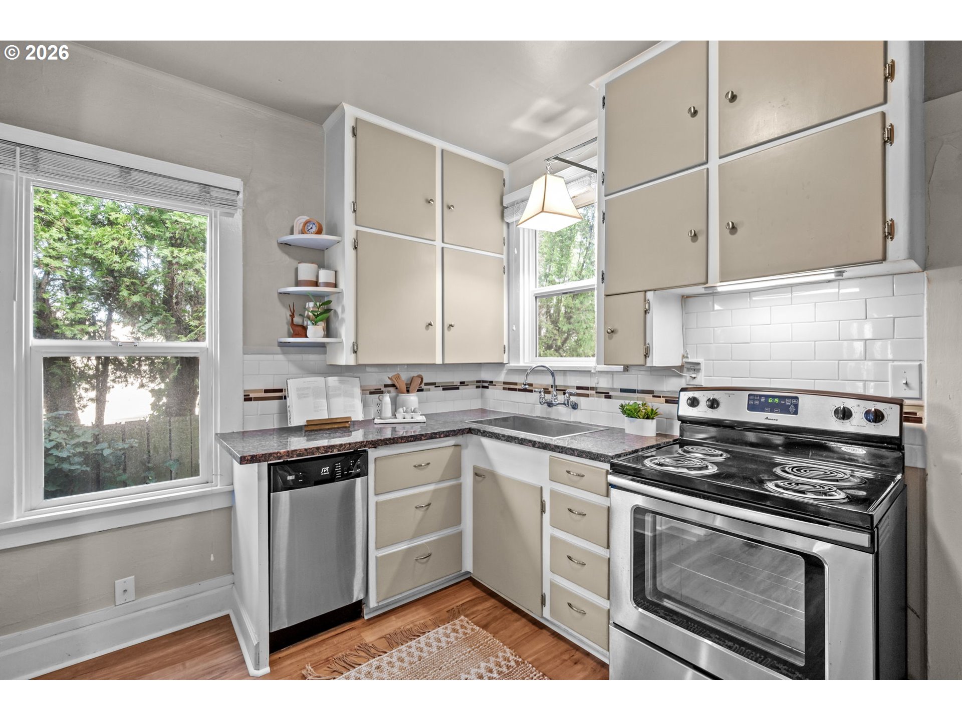 326 Pearl Street Oregon City, OR 97045 - Photo 15 of 36 a kitchen with white cabinets appliances and a window