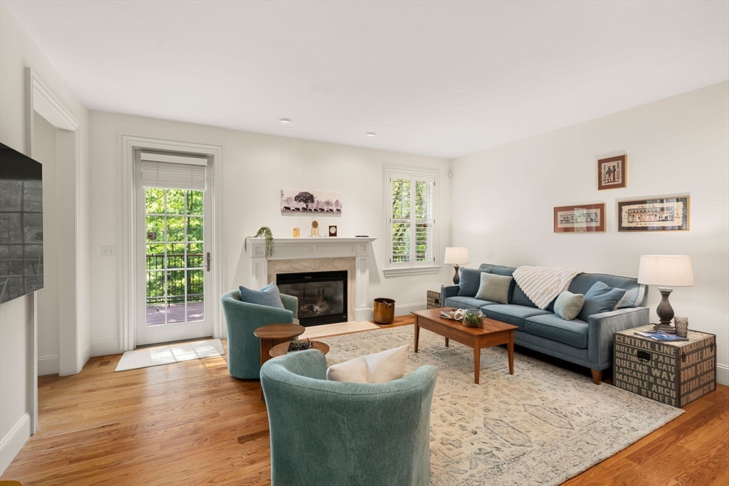 287 Langley Road, Unit 43 Newton, MA 02459 - Photo 12 of 36 a living room with furniture and a fireplace