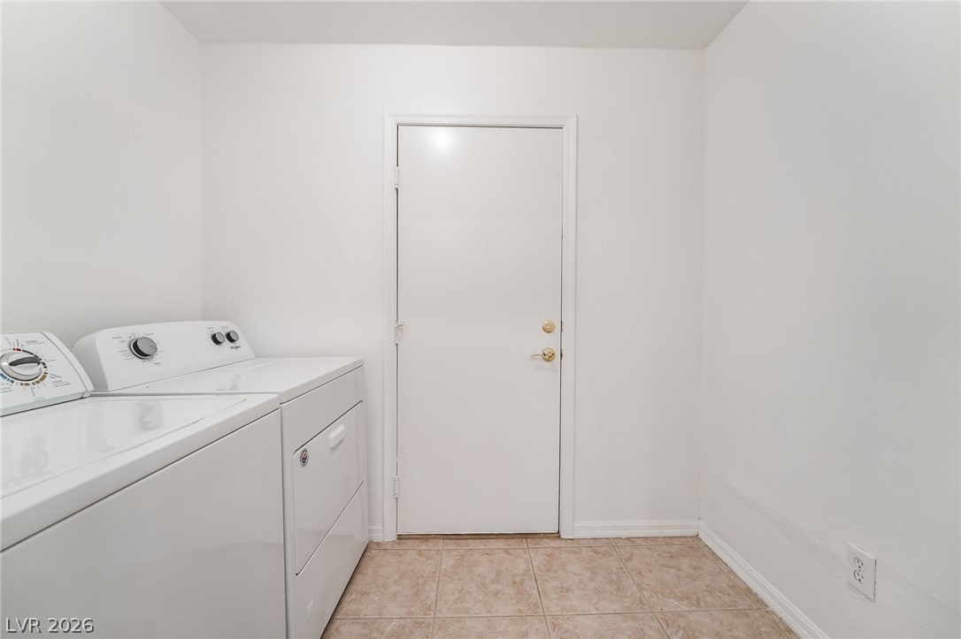 5389 Progresso Street Las Vegas, NV 89135 - Photo 25 of 41 Functional laundry space featuring modern appliances and a robust tiled floor.
