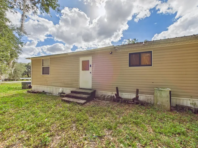 a view of a backyard with chairs