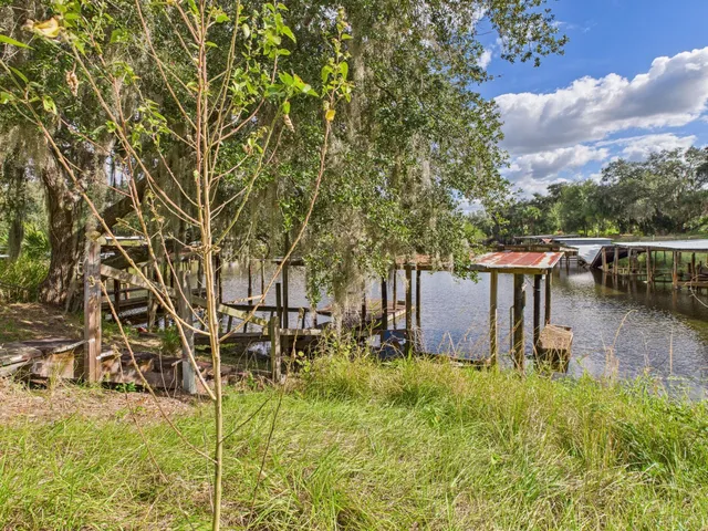 a view of a backyard with wooden fence