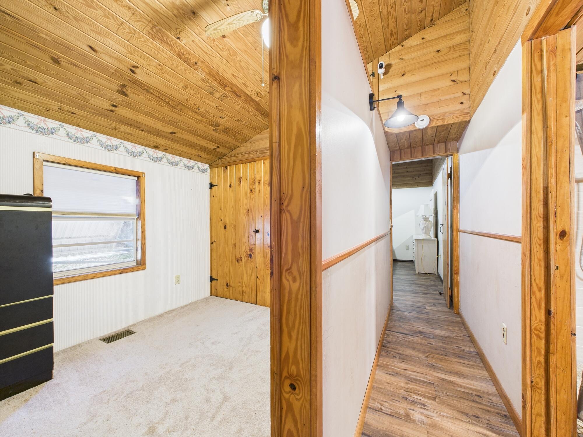 56 Basin Street Lorida, FL 33857 - Photo 27 of 42 a view of a hallway with wooden walls and windows
