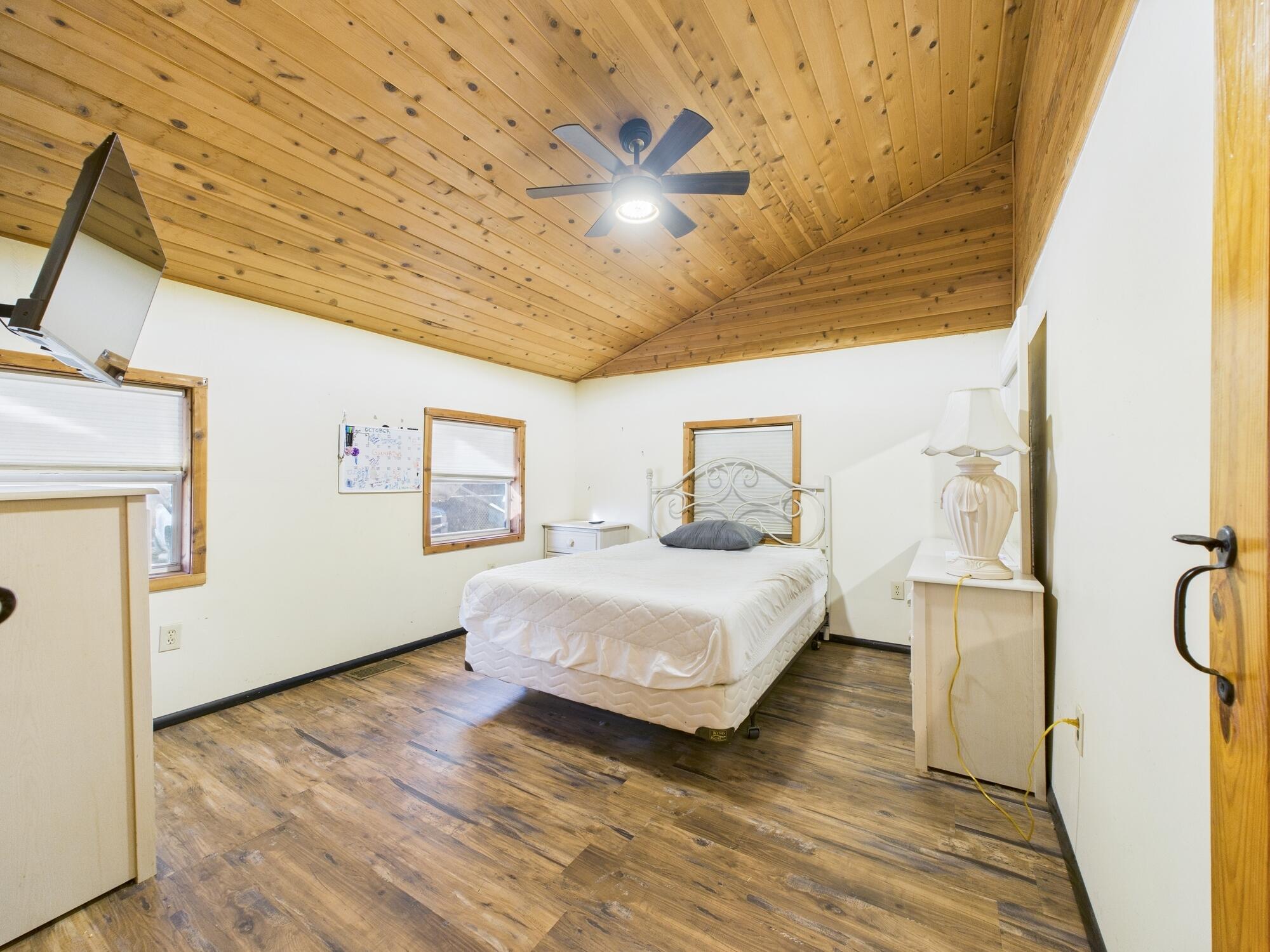 56 Basin Street Lorida, FL 33857 - Photo 28 of 42 a bedroom with a bed and wooden floor