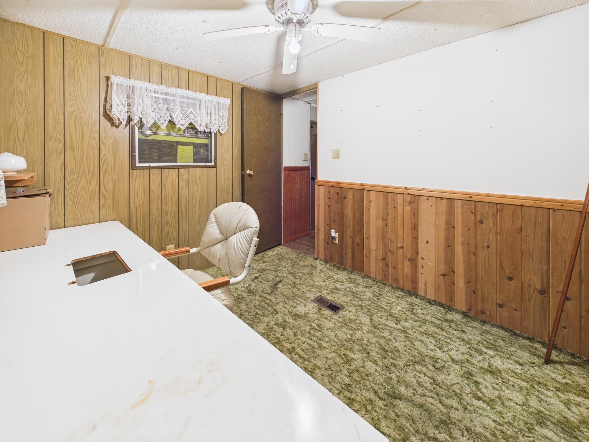 56 Basin Street Lorida, FL 33857 - Photo 35 of 42 a bedroom with a bed and a chandelier