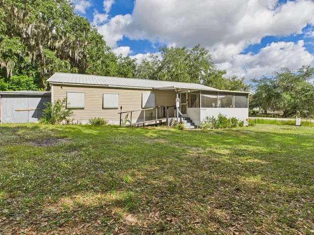 a view of a house with yard and sitting area