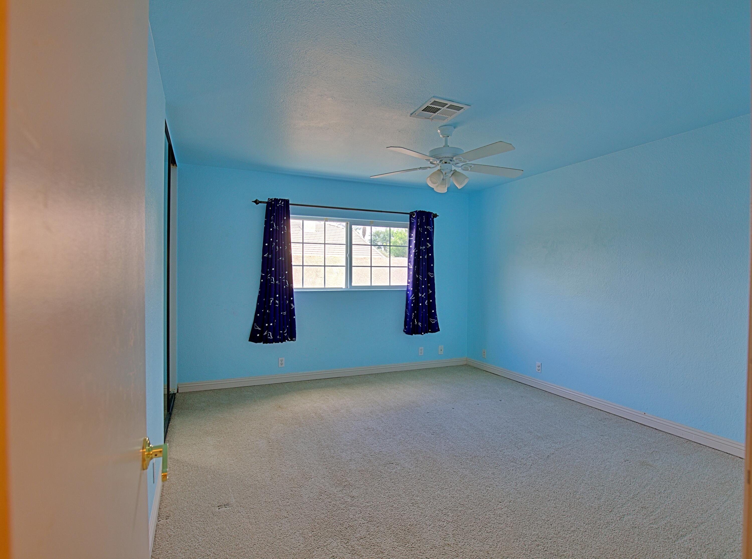 80025 Kingston Drive Bermuda Dunes, CA 92203 - Photo 13 of 27 an empty room with windows and fan
