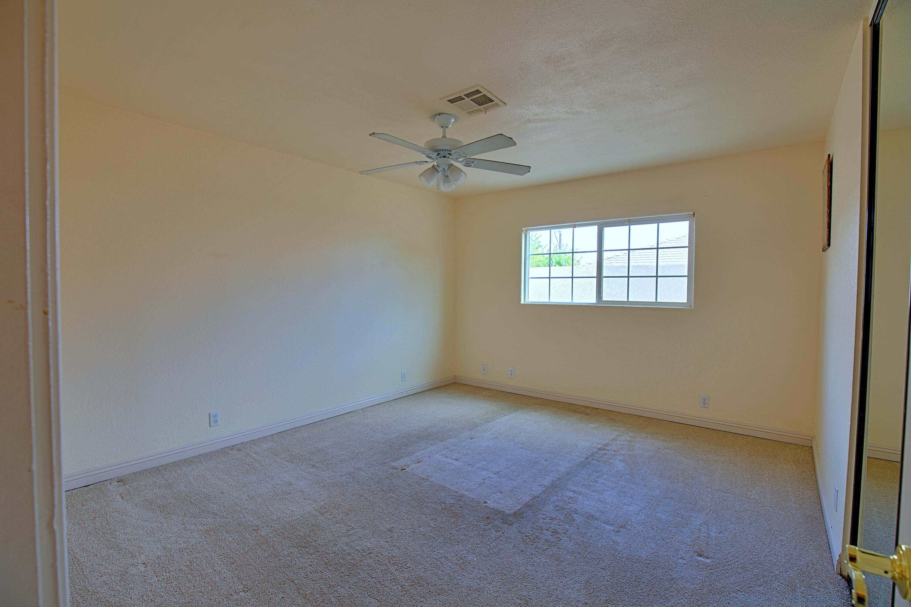 80025 Kingston Drive Bermuda Dunes, CA 92203 - Photo 14 of 27 an empty room with windows and fan