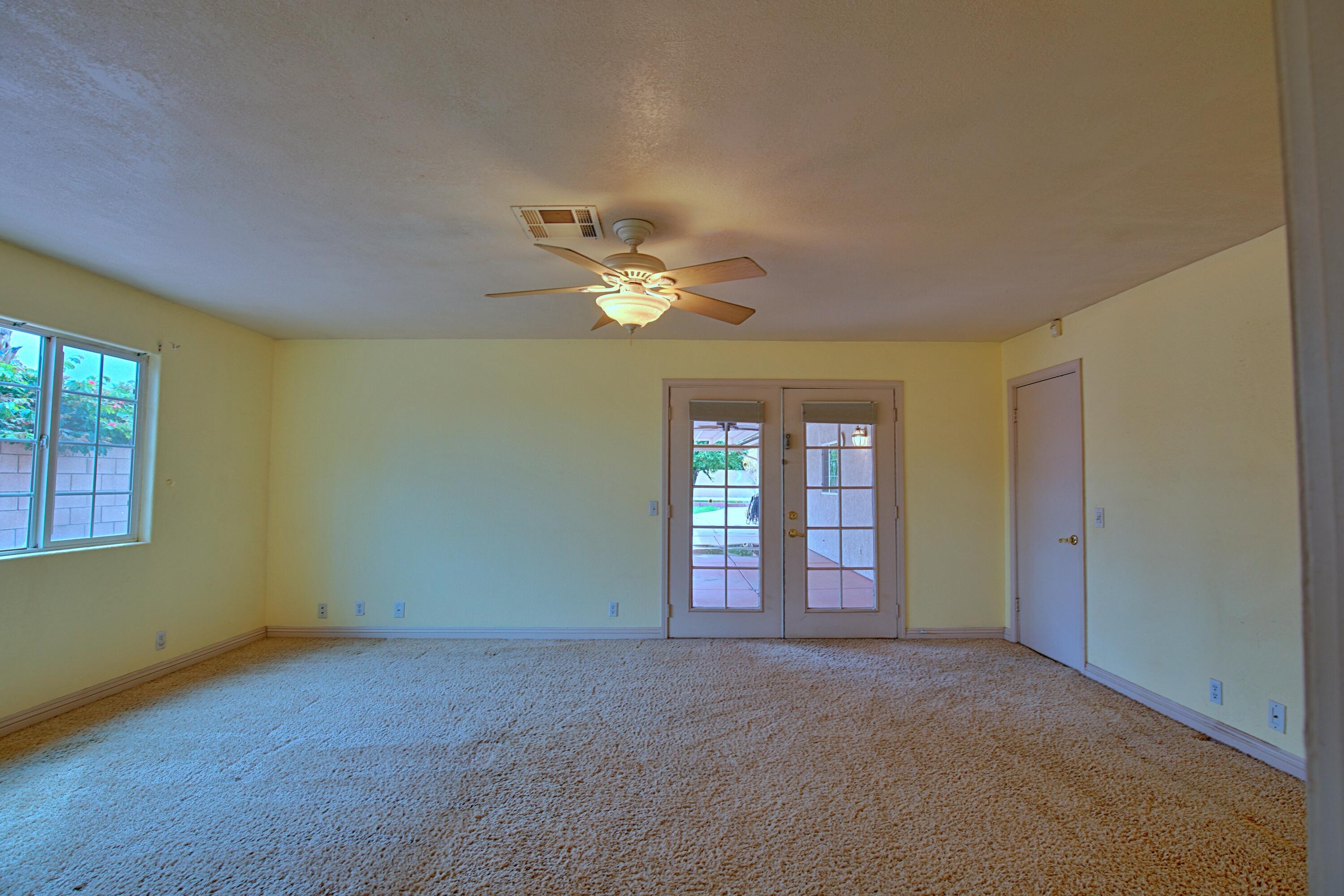 80025 Kingston Drive Bermuda Dunes, CA 92203 - Photo 16 of 27 a view of a livingroom with a ceiling fan and window