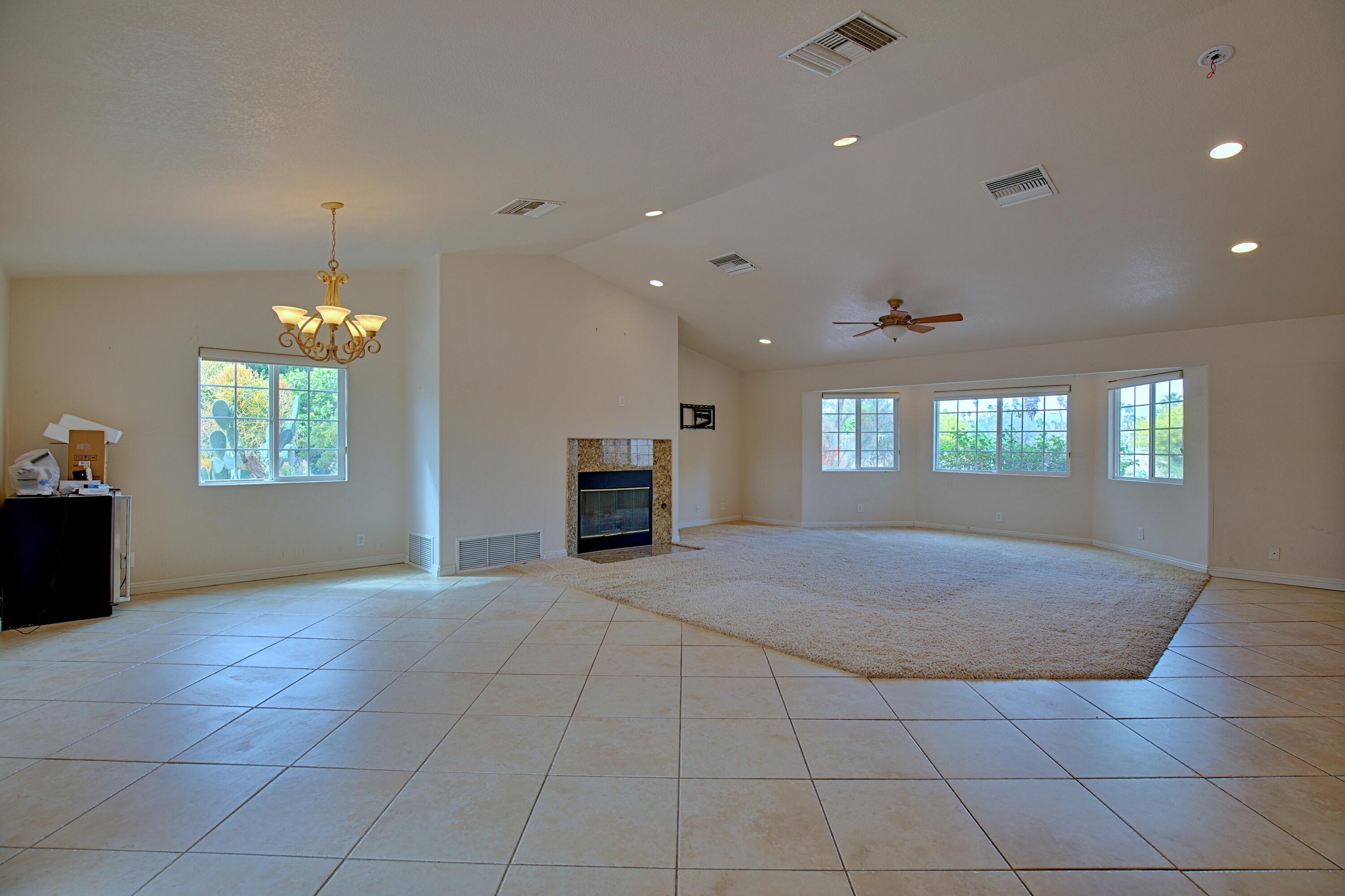 80025 Kingston Drive Bermuda Dunes, CA 92203 - Photo 4 of 27 a view of an empty room with a window and fireplace