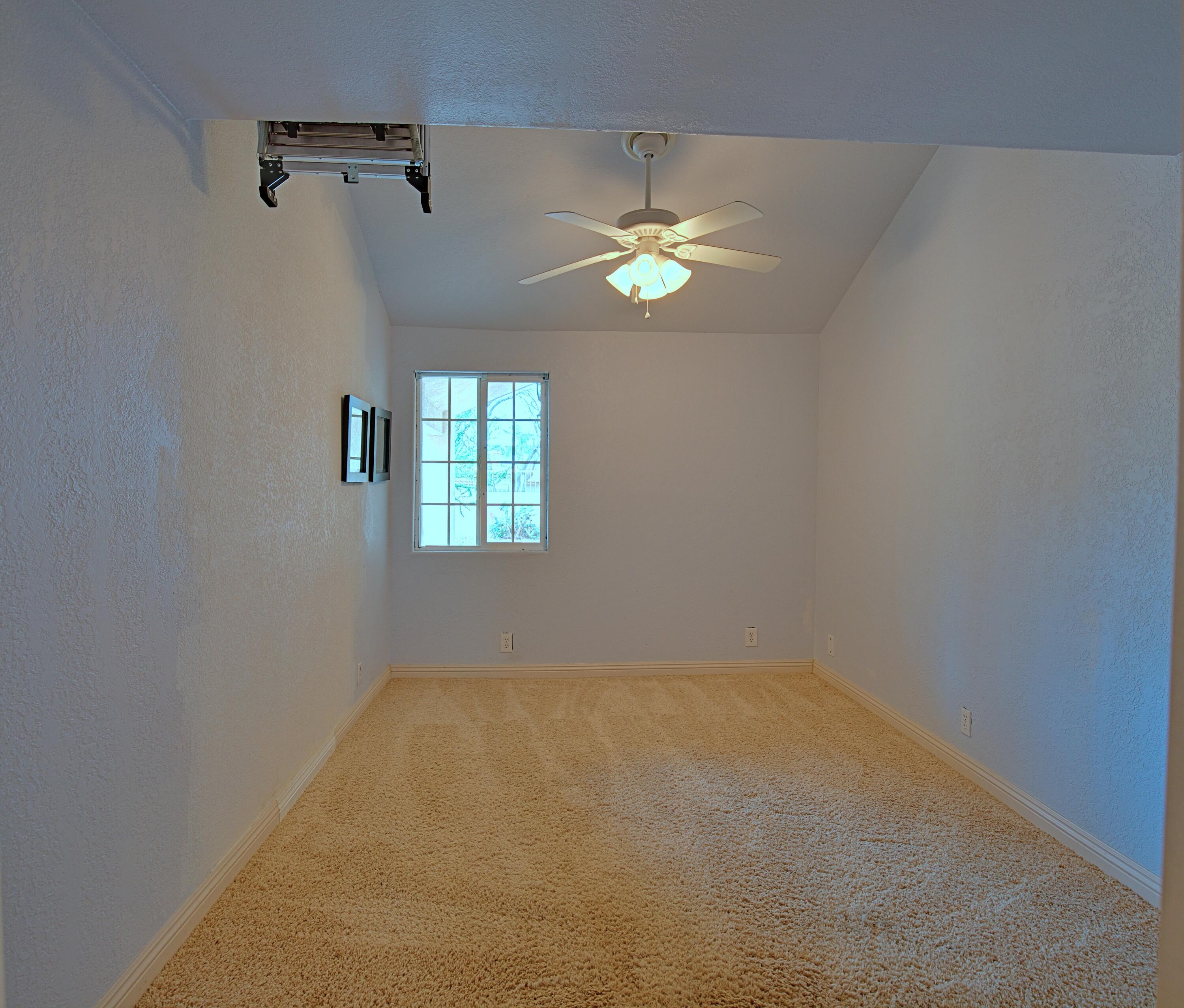 80025 Kingston Drive Bermuda Dunes, CA 92203 - Photo 10 of 27 an empty room with a window and a ceiling fan