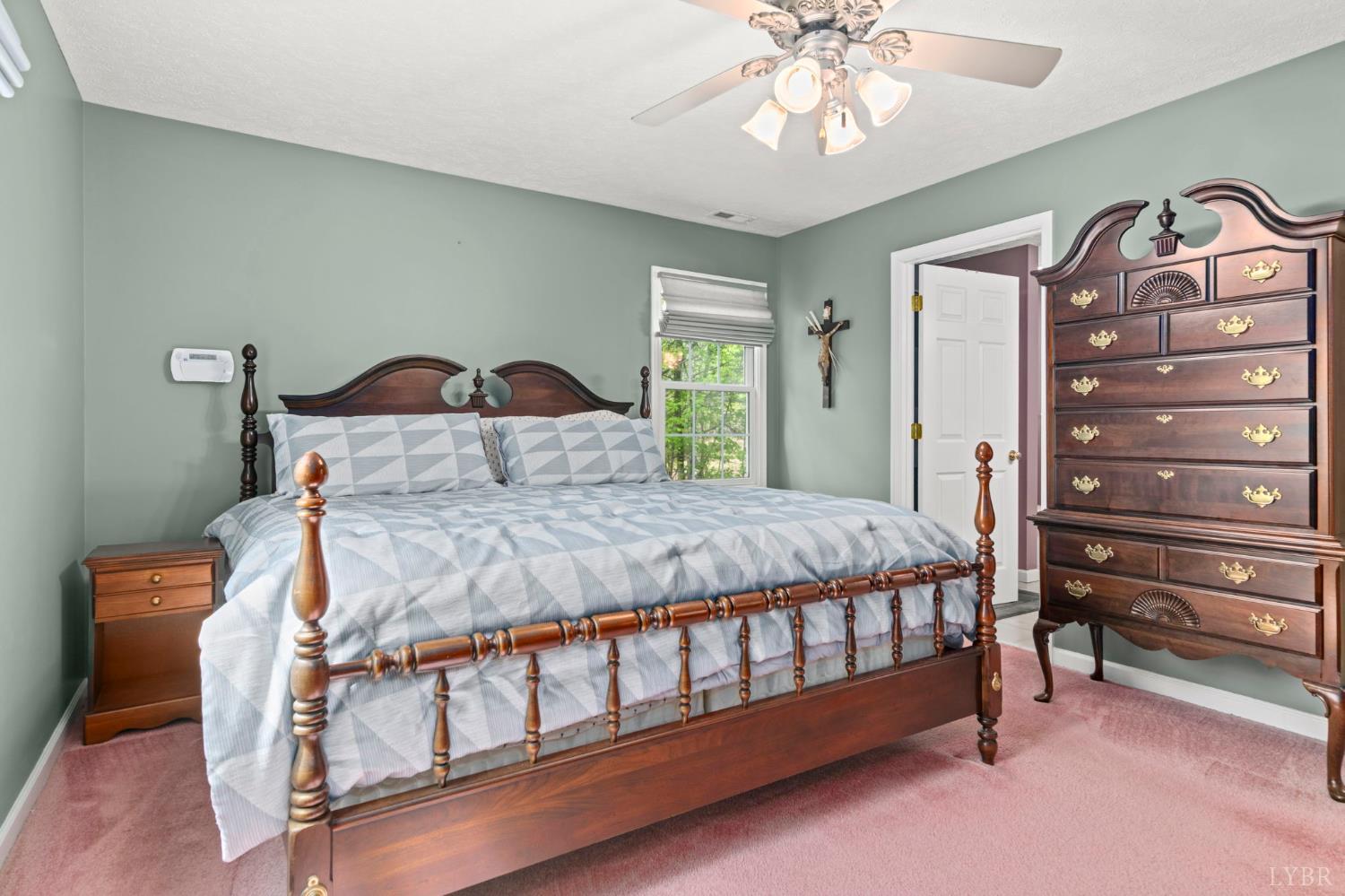 298 Braxton Ridge Road Amherst, VA 24521 - Photo 22 of 65 a bedroom with a bed and a chandelier