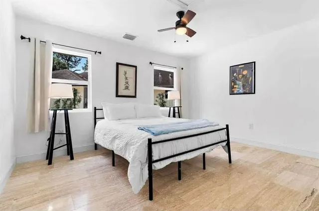a bedroom with a bed and a chandelier