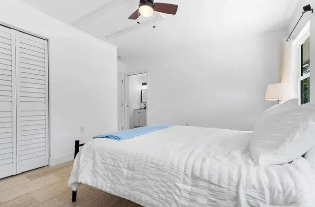 a bedroom with a bed and a window