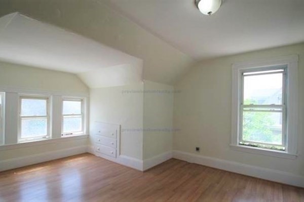 32 Mansfield Street Boston, MA 02134 - Photo 13 of 20 an empty room with wooden floor and windows