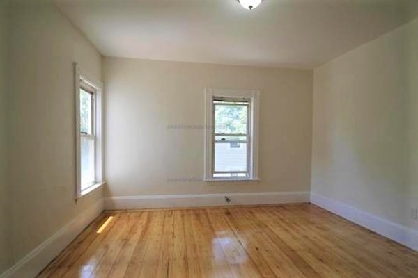 32 Mansfield Street Boston, MA 02134 - Photo 15 of 20 an empty room with wooden floor and windows