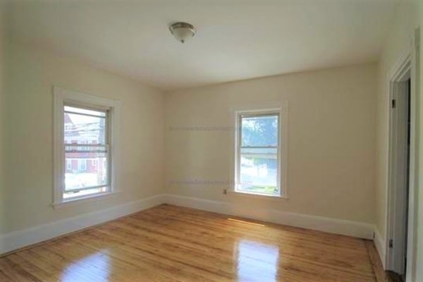 32 Mansfield Street Boston, MA 02134 - Photo 17 of 20 a view of an empty room with wooden floor and a window