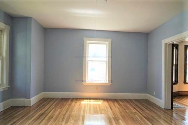 32 Mansfield Street Boston, MA 02134 - Photo 4 of 20 a view of an empty room with wooden floor and a window
