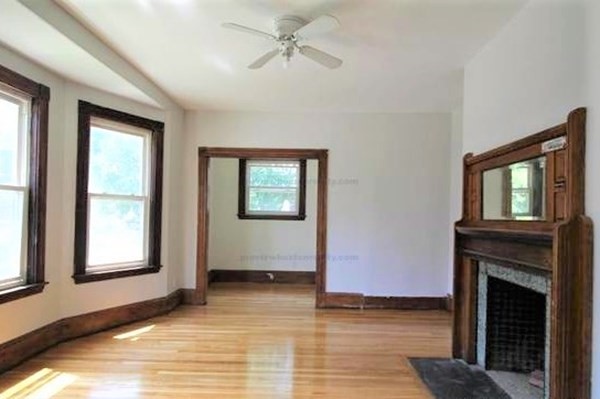 32 Mansfield Street Boston, MA 02134 - Photo 5 of 20 wooden floor fireplace and windows in an empty room