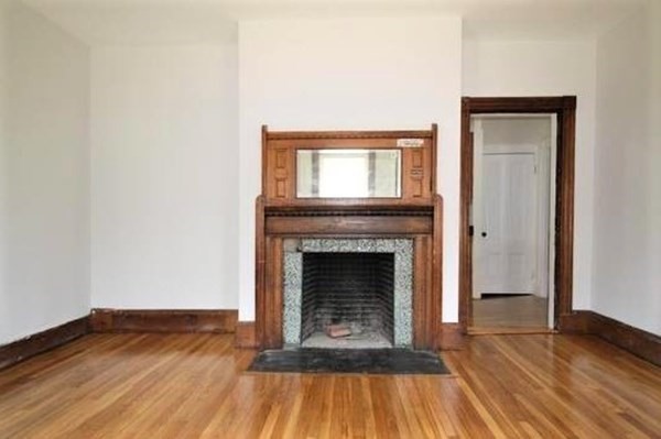 32 Mansfield Street Boston, MA 02134 - Photo 7 of 20 a living room with a fireplace and wooden floor