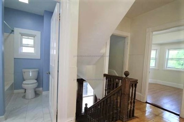 32 Mansfield Street Boston, MA 02134 - Photo 9 of 20 a bathroom with a toilet a sink and mirror