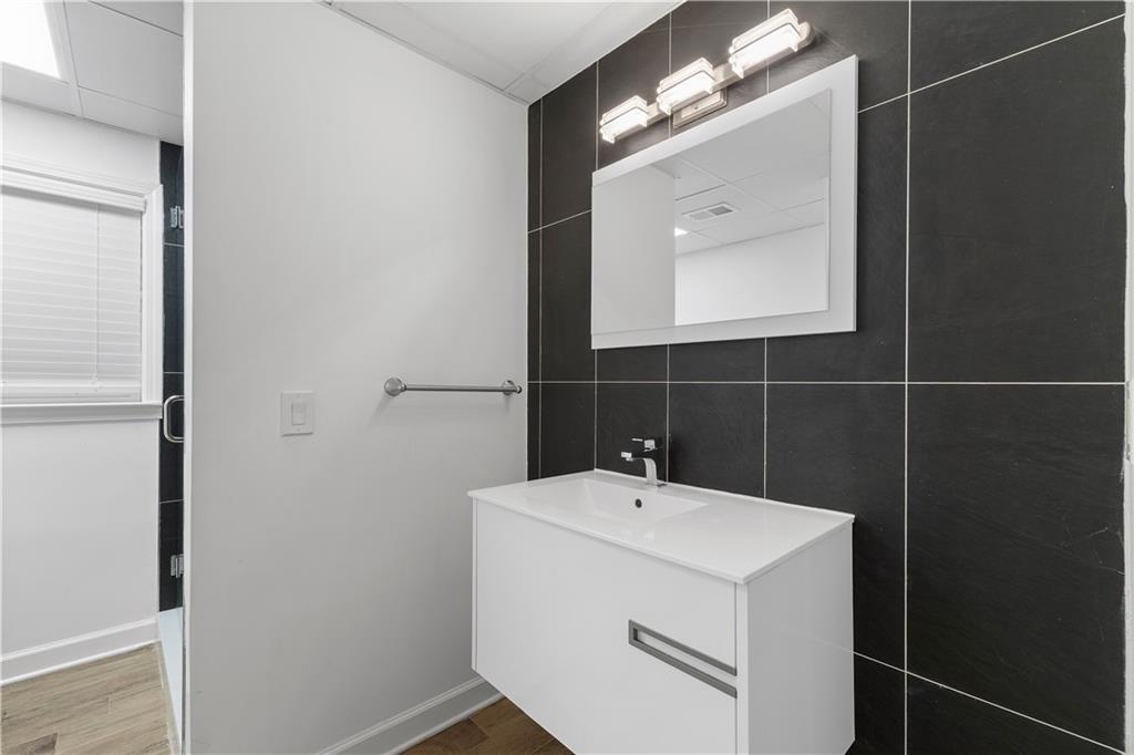 8965 Laurel Way Alpharetta, GA 30022 - Photo 48 of 79 a bathroom with a sink and a mirror