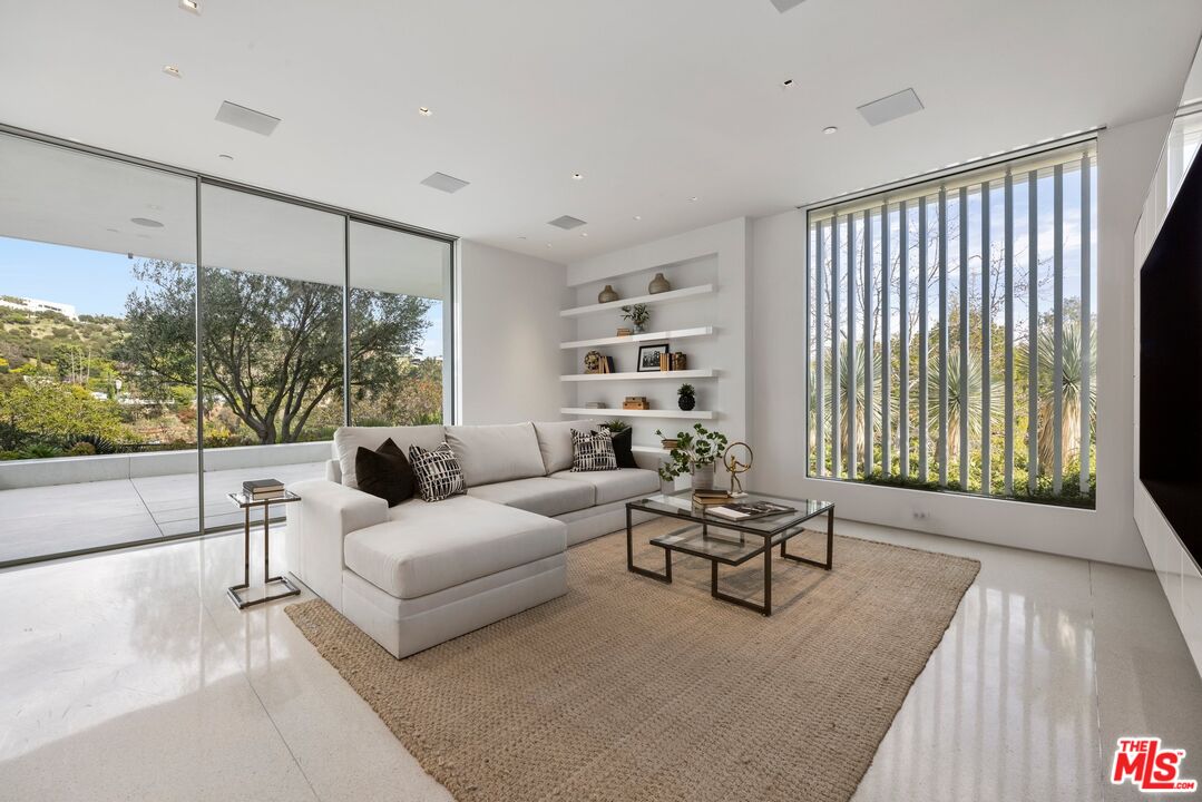12251 Castlegate Drive Los Angeles, CA 90049 - Photo 14 of 30 a living room with furniture and a large window