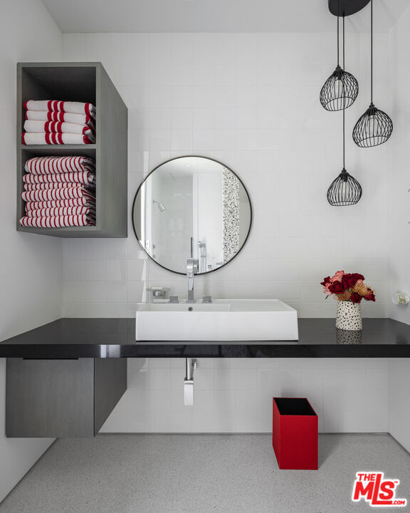 12251 Castlegate Drive Los Angeles, CA 90049 - Photo 18 of 30 a bathroom with a sink and a mirror