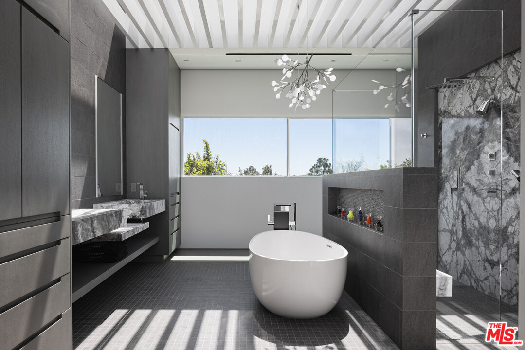 12251 Castlegate Drive Los Angeles, CA 90049 - Photo 23 of 30 a bathroom with a sink and a mirror