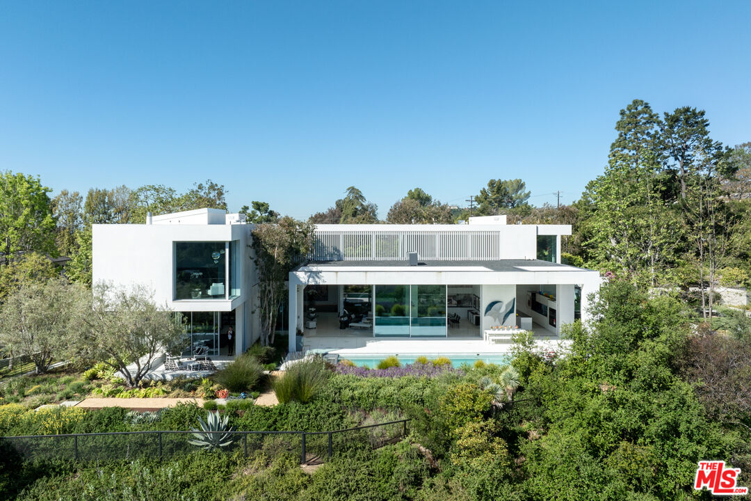 12251 Castlegate Drive Los Angeles, CA 90049 - Photo 27 of 30 a front view of a house with a yard