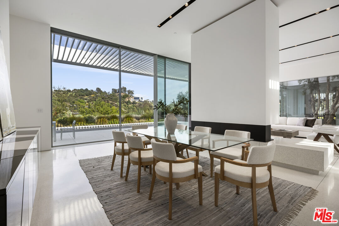 12251 Castlegate Drive Los Angeles, CA 90049 - Photo 10 of 30 a view of a dining room with furniture window and wooden floor