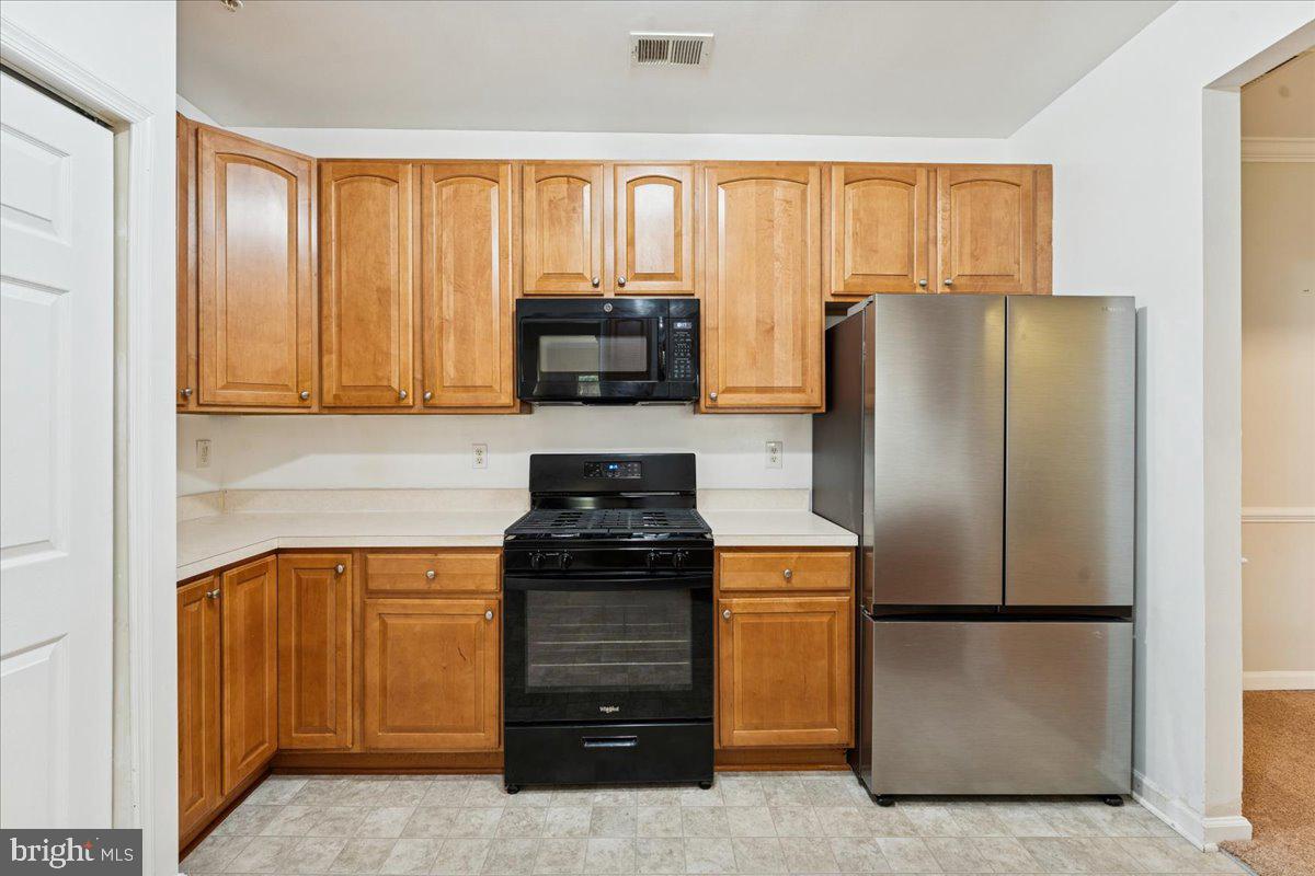 2000 Connor Court, Unit 705C Bowie, MD 20721 - Photo 13 of 28 a kitchen with stainless steel appliances granite countertop a refrigerator and a stove