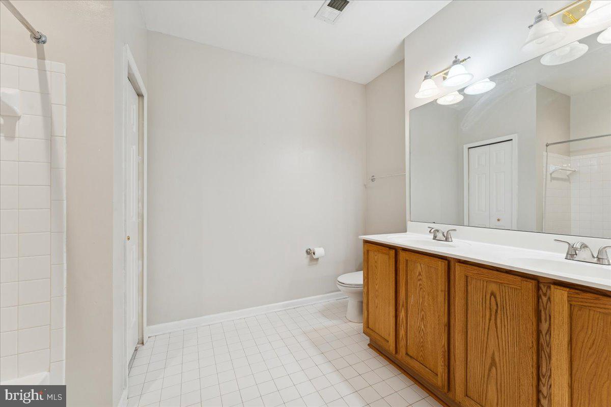 2000 Connor Court, Unit 705C Bowie, MD 20721 - Photo 22 of 28 a bathroom with a sink a large mirror and a toilet