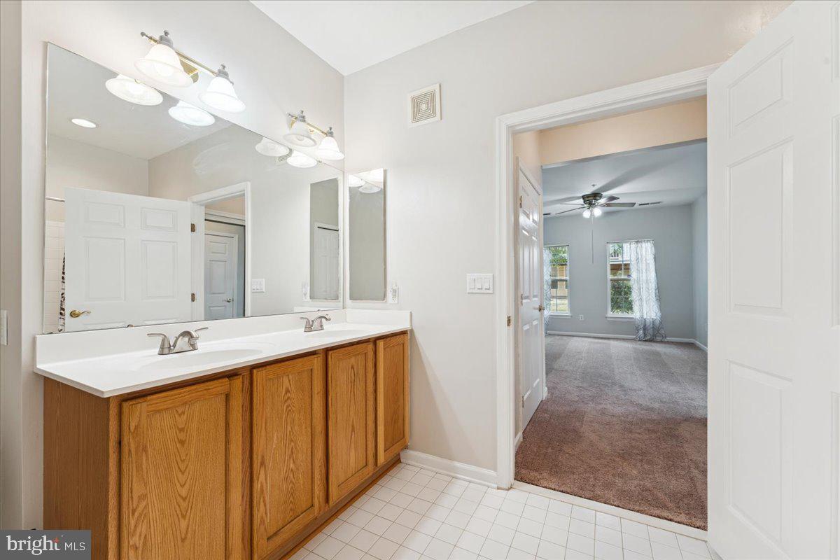 2000 Connor Court, Unit 705C Bowie, MD 20721 - Photo 24 of 28 a bathroom with a double vanity sink and a mirror