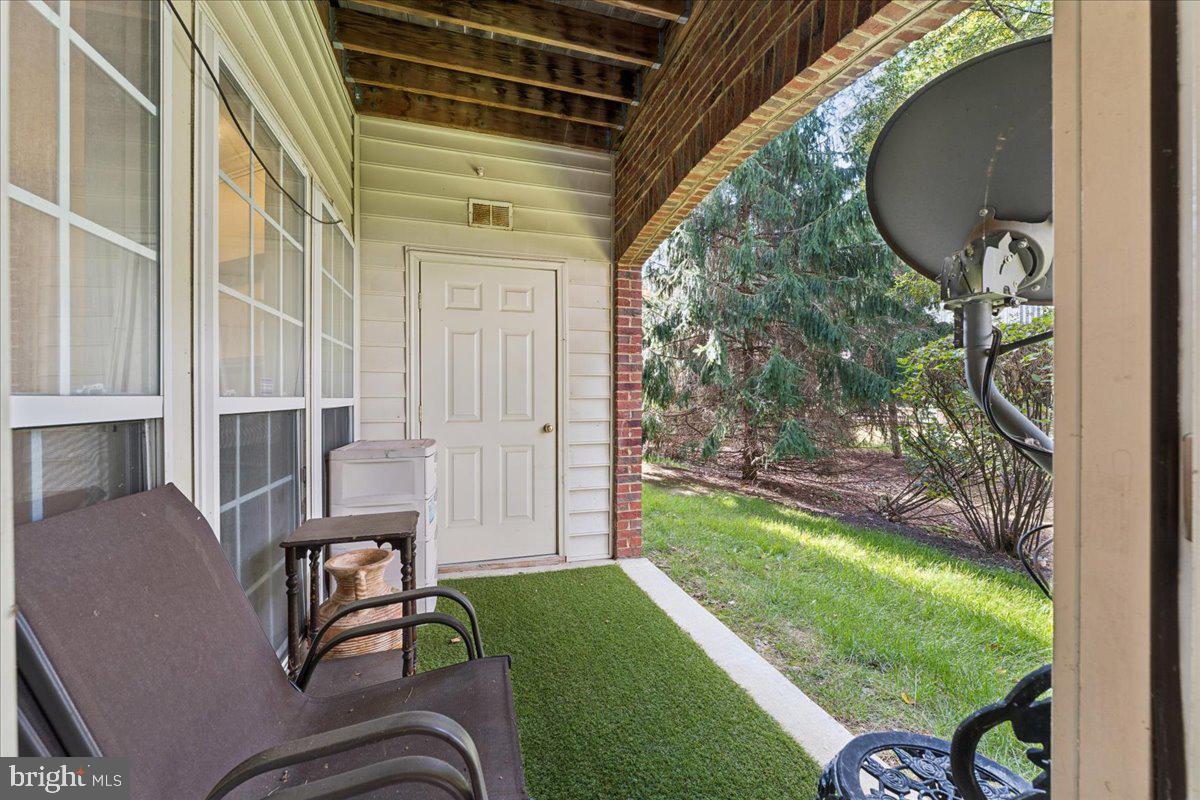 2000 Connor Court, Unit 705C Bowie, MD 20721 - Photo 26 of 28 a backyard of a house with table and chairs