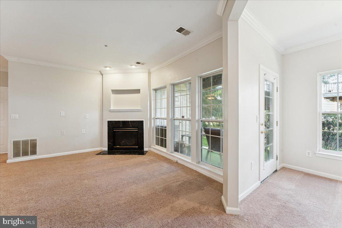 2000 Connor Court, Unit 705C Bowie, MD 20721 - Photo 7 of 28 an empty room with windows and fireplace
