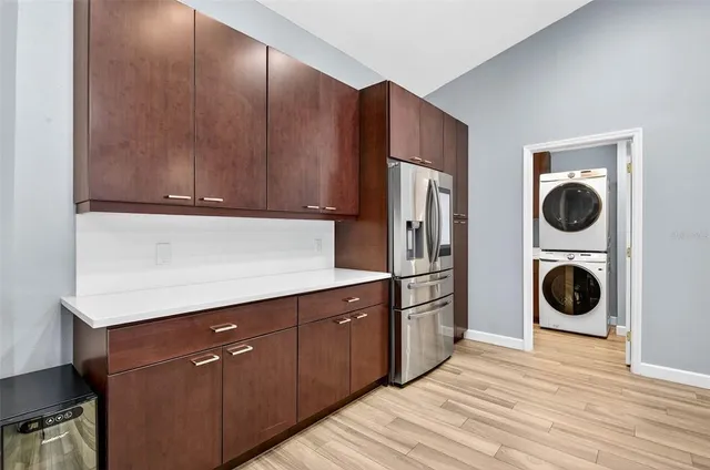 a kitchen with a refrigerator and a stove top oven