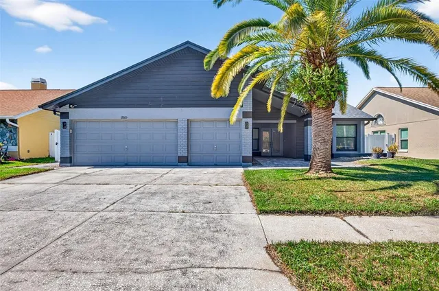 a front view of a house with a garden and trees