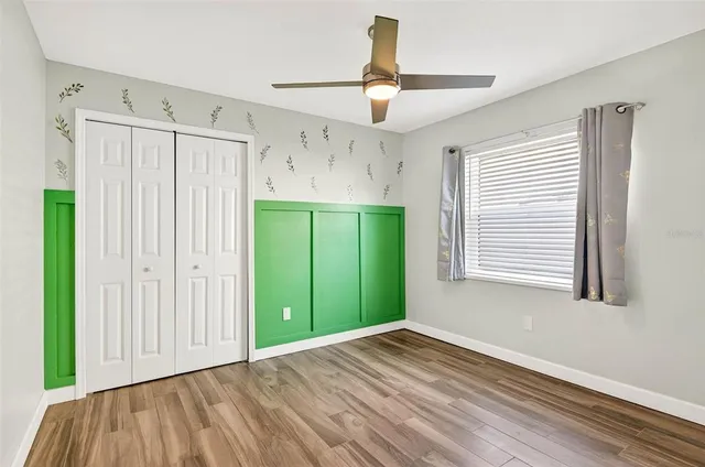 a view of a room with window wooden floor and a ceiling fan