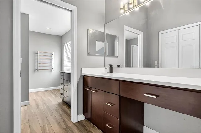 a en suite bathroom with a sink mirror and a toilet